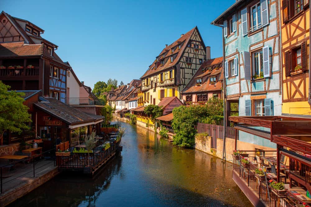 Ein von farbenfrohen Gebäuden gesäumter Kanal in Straßburg, einer Stadt in Frankreich, die für ihre Sehenswürdigkeiten bekannt ist.